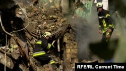 Rescue workers search the rubble of an apartment building in Kyiv after a Russian strike.