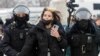 RUSSIA -- Law enforcement officers detain a woman during a rally in support of jailed Russian opposition leader Alexei Navalny in Moscow, Russia January 31, 2021. 