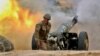 NAGORN-KARABAKH -- A serviceman of Karabakh's Defence Army fires an artillery piece towards Azeri positions during fighting over the breakaway Nagorno Karabakh region, September 28, 2020