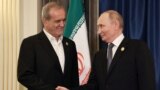 Russian President Vladimir Putin (right) shakes hands with Iran's President Masud Pezeshkian on the sidelines of the Shanghai Cooperation Organization summit in China on September 1.